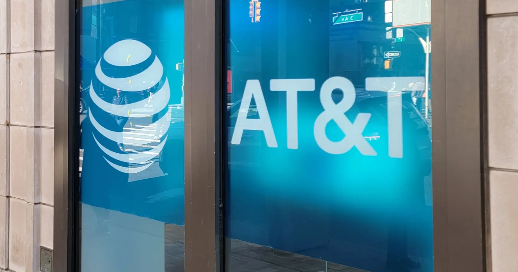 An AT&T store window advertising switcher offers