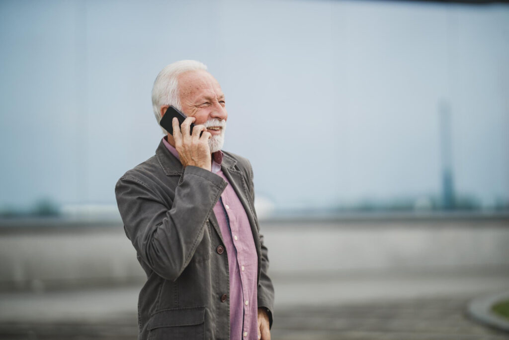 An older adult using a smartphone with Consumer Cellular service