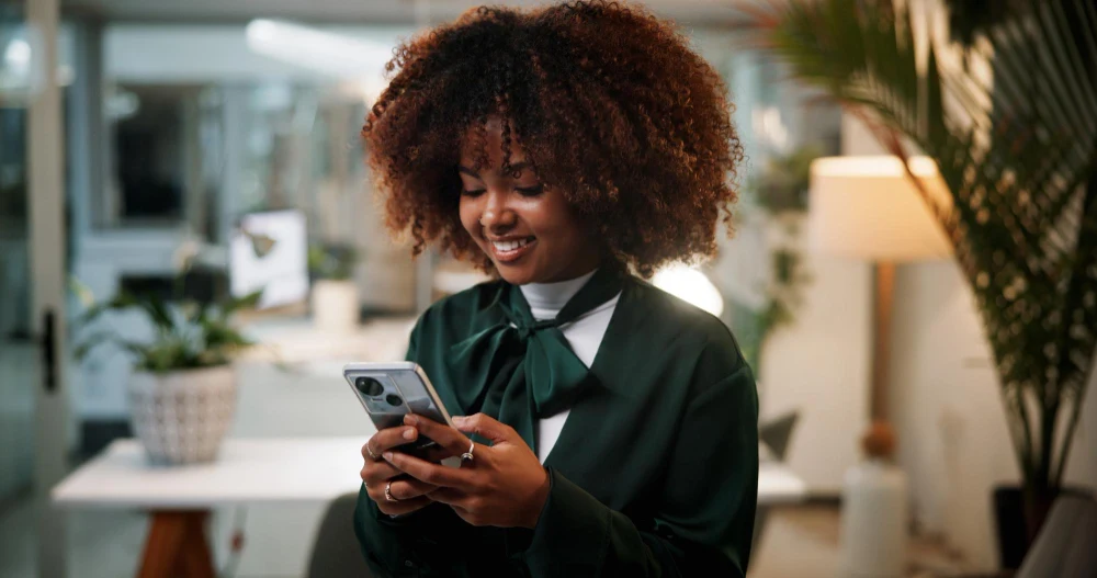 A woman using her phone in an office